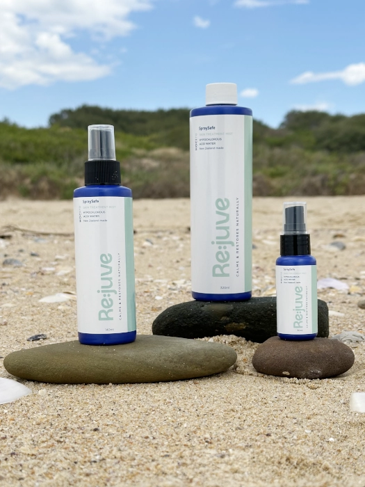 Image shows re:juve HOCL hypochlorous acid spray starter pack on an Australian beach